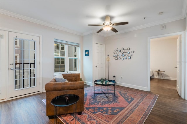 living area with dark hardwood / wood-style floors, ceiling fan, and ornamental molding