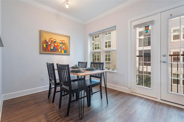 dining area with french doors, crown molding, and dark hardwood / wood-style floors