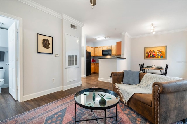 living room with crown molding and dark hardwood / wood-style flooring