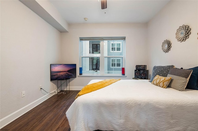 bedroom with ceiling fan and dark hardwood / wood-style flooring