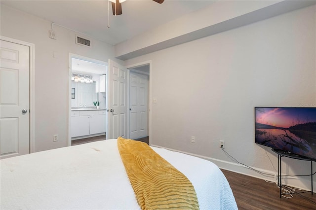 bedroom with ceiling fan, sink, connected bathroom, and dark hardwood / wood-style flooring