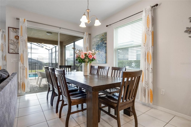 tiled dining area featuring an inviting chandelier