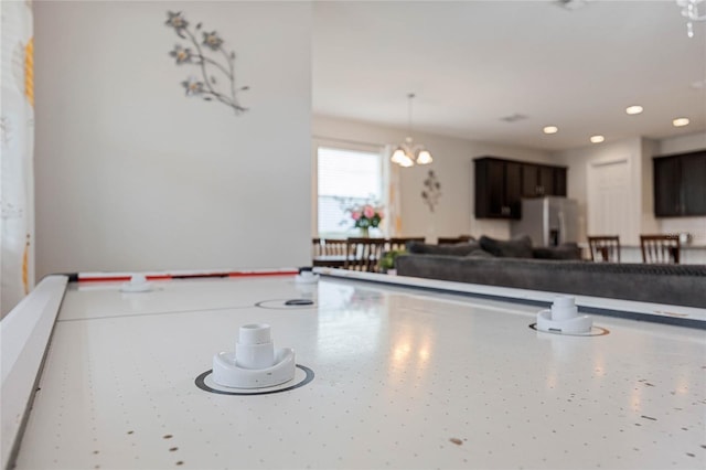 kitchen featuring decorative light fixtures, stainless steel fridge, and a chandelier