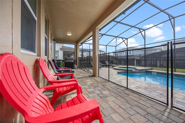 view of patio / terrace featuring a lanai, a pool with hot tub, and grilling area