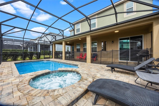 view of pool with an in ground hot tub, a lanai, and a patio