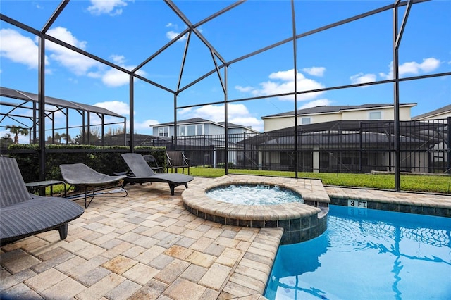 view of swimming pool with an in ground hot tub, glass enclosure, and a patio