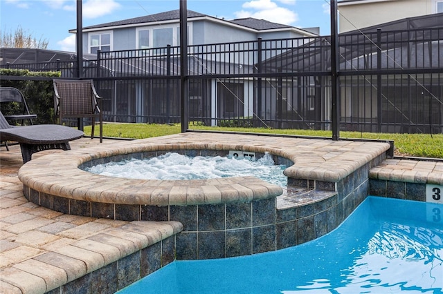 view of pool featuring an in ground hot tub