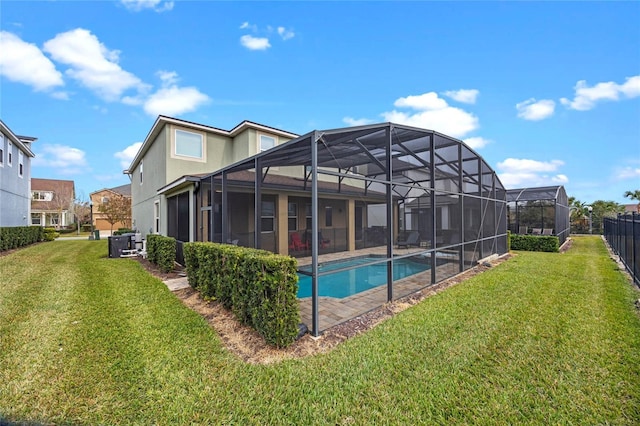 rear view of house featuring a lanai and a yard