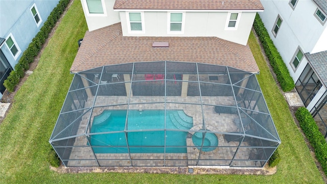 rear view of property with a lanai, a patio area, and a yard