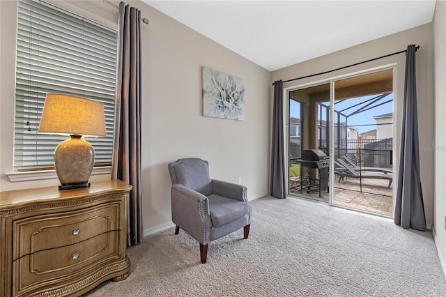 sitting room featuring light colored carpet and lofted ceiling