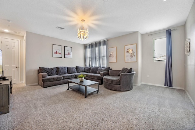 living room featuring light carpet, a textured ceiling, and plenty of natural light