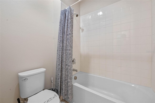 bathroom with toilet and shower / tub combo