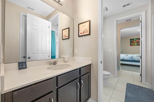 bathroom featuring tile patterned floors, toilet, and vanity