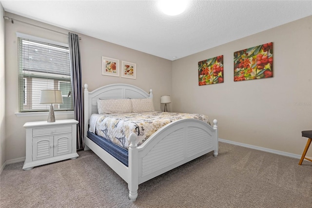 carpeted bedroom featuring a textured ceiling