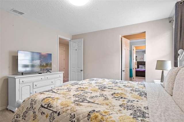 carpeted bedroom with a textured ceiling