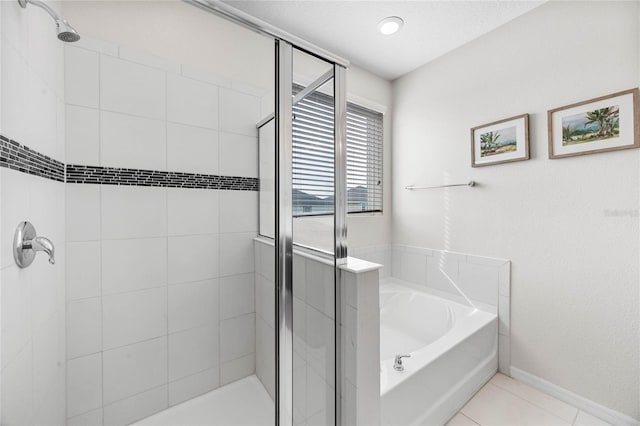 bathroom with tile patterned floors and separate shower and tub