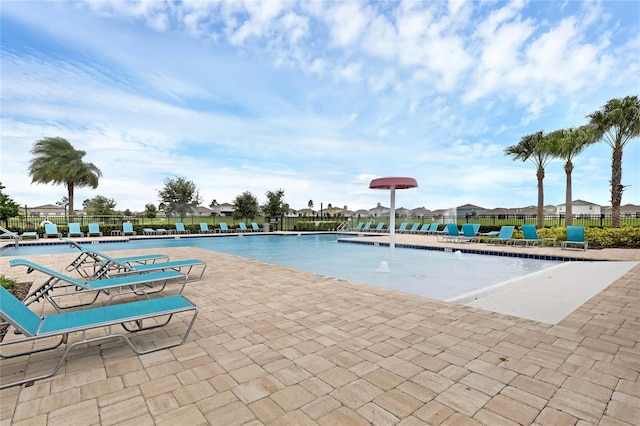 view of swimming pool with a patio area and pool water feature