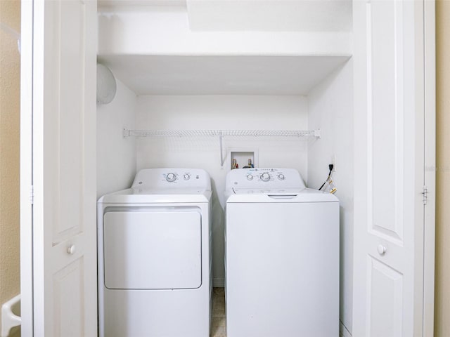 washroom with washing machine and clothes dryer