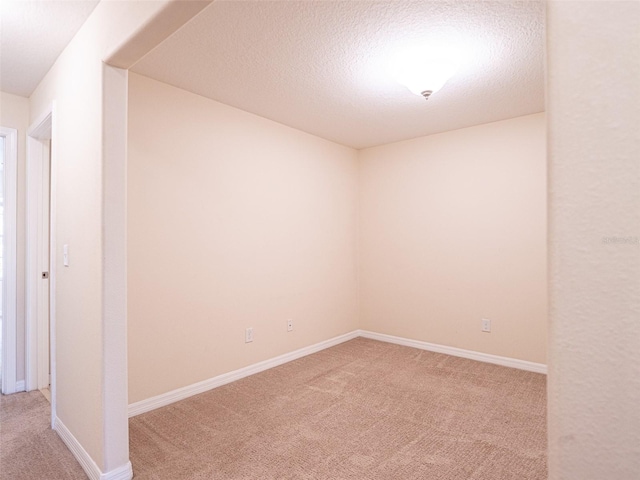 carpeted spare room featuring a textured ceiling