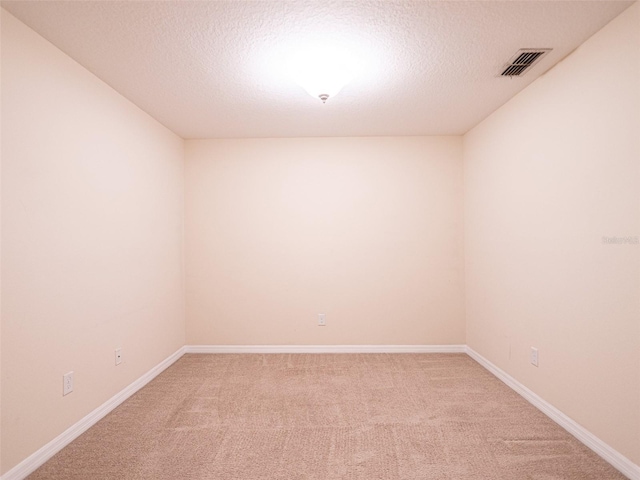 spare room with carpet floors and a textured ceiling