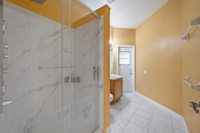 bathroom featuring vanity, toilet, an enclosed shower, and tile patterned flooring