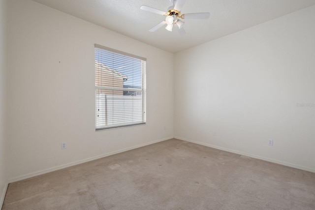 empty room with ceiling fan and light colored carpet