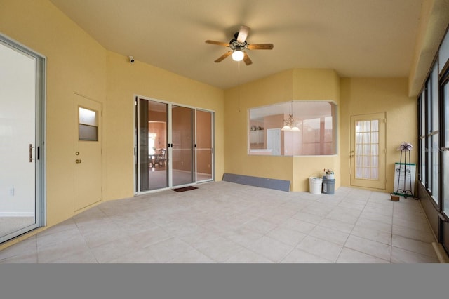 interior space with ceiling fan with notable chandelier