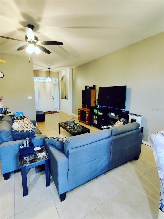 tiled living room with ceiling fan