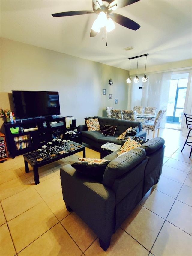 tiled living room with ceiling fan