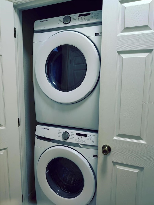 laundry room with stacked washer and clothes dryer