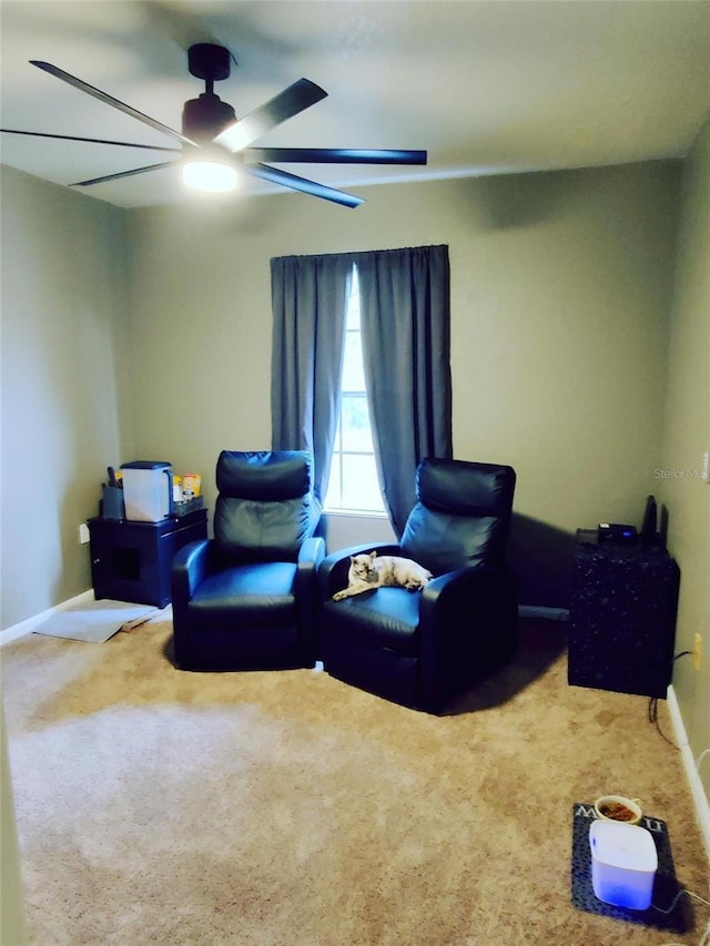 sitting room featuring ceiling fan and carpet