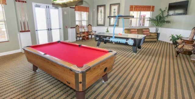 recreation room with a healthy amount of sunlight, dark carpet, and french doors