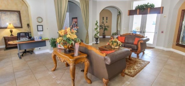 sitting room featuring french doors and light tile patterned flooring