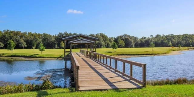 dock area with a gazebo, a lawn, and a water view