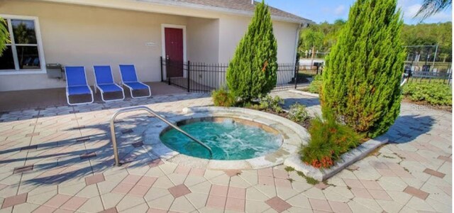 view of pool with an in ground hot tub and a patio area