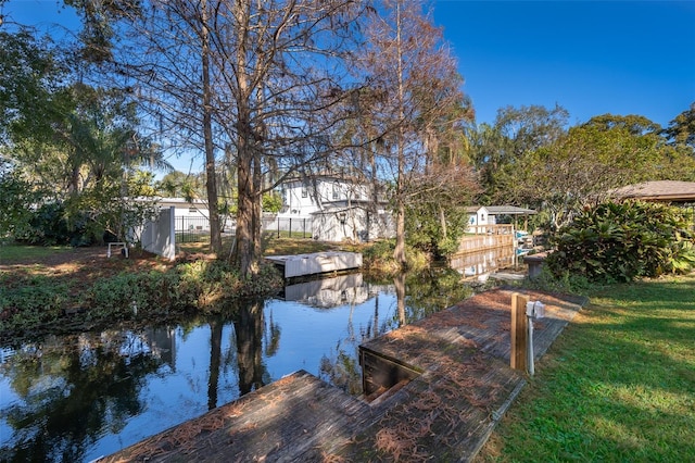 exterior space featuring a water view and a lawn