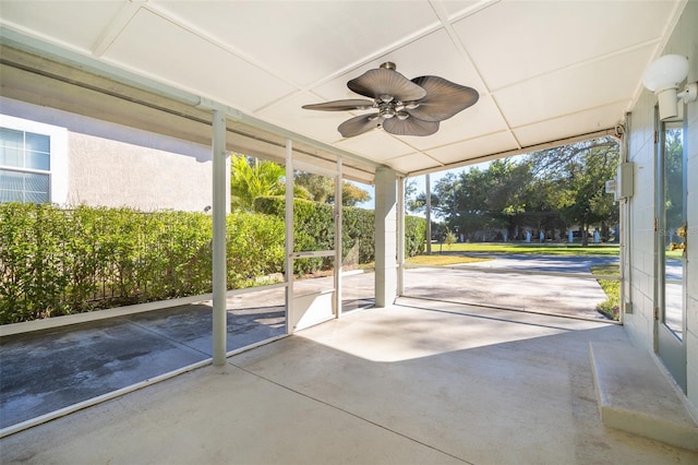 unfurnished sunroom with ceiling fan