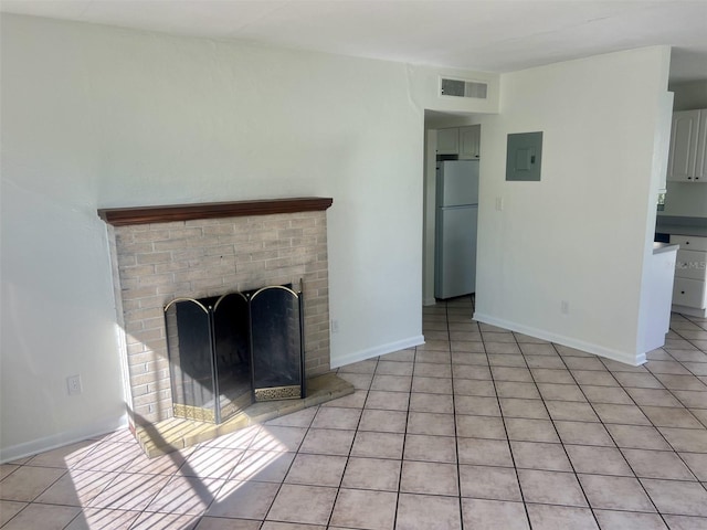 unfurnished living room featuring a fireplace, electric panel, and light tile patterned floors