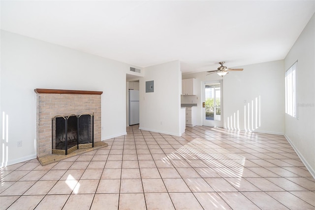 unfurnished living room featuring light tile patterned flooring, ceiling fan, a fireplace, and electric panel