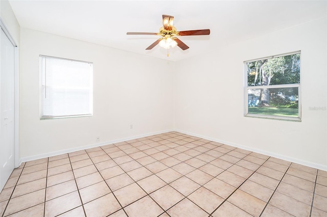 unfurnished room featuring light tile patterned floors and ceiling fan