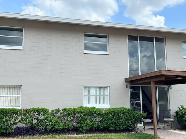 5885 Dahlia Dr Unit 29/115, Orlando, FL 32807 - view of home's exterior with concrete block siding and a patio area