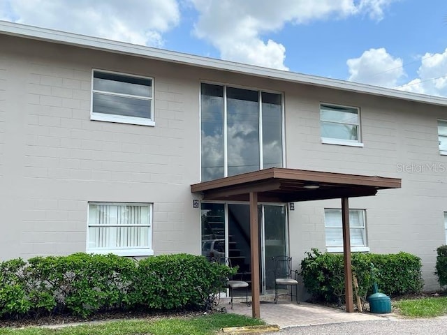 5885 Dahlia Dr Unit 30/215, Orlando, FL 32807 - view of front of house featuring concrete block siding and a patio