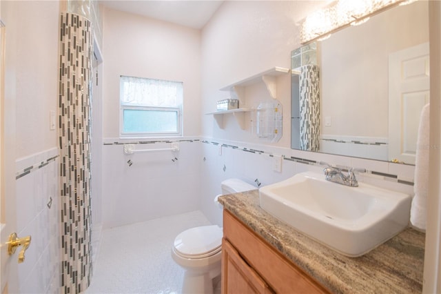 bathroom with vanity, tile walls, a shower with shower curtain, and toilet