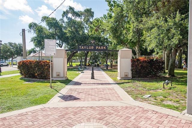 view of gate with a lawn