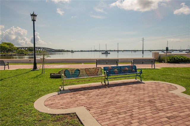 view of property's community featuring a water view and a lawn