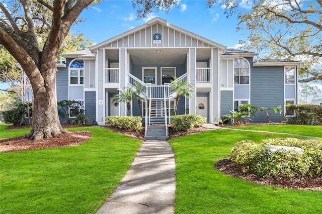 731 Sugar Bay Way Unit 103, Lake Mary, FL 32746 - view of front of home with stairs, a front lawn, and board and batten siding