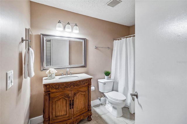 bathroom featuring tile patterned floors, vanity, toilet, and a textured ceiling