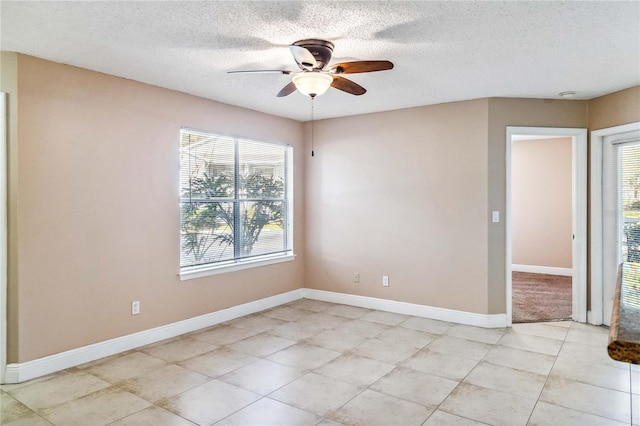 unfurnished room featuring ceiling fan and a textured ceiling