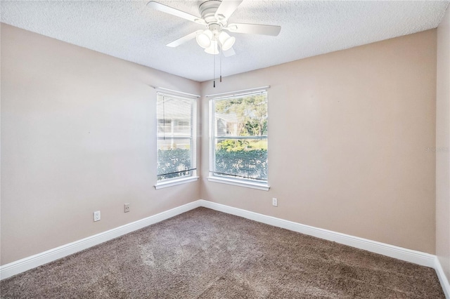 empty room with a textured ceiling, ceiling fan, and carpet