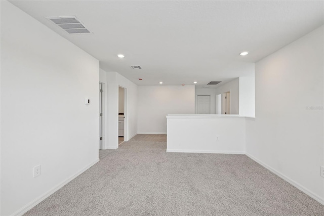 unfurnished room with recessed lighting, visible vents, light carpet, and baseboards